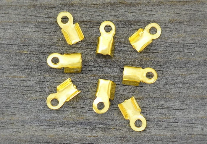 27111 Końcówka sznurka 6*4mm w kolorze złota 100szt 