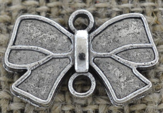 312140 Element ozdobny łącznik kokardka w kolorze srebrnym 3szt