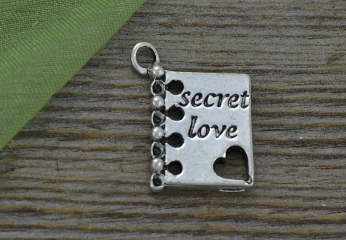 307197 Zawieszka mała książka z napisem secret love w kolorze srebrnym